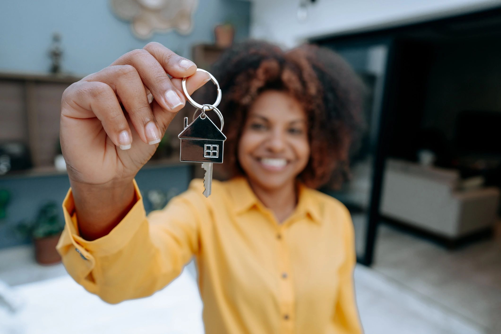 Hand holding house keys after closing