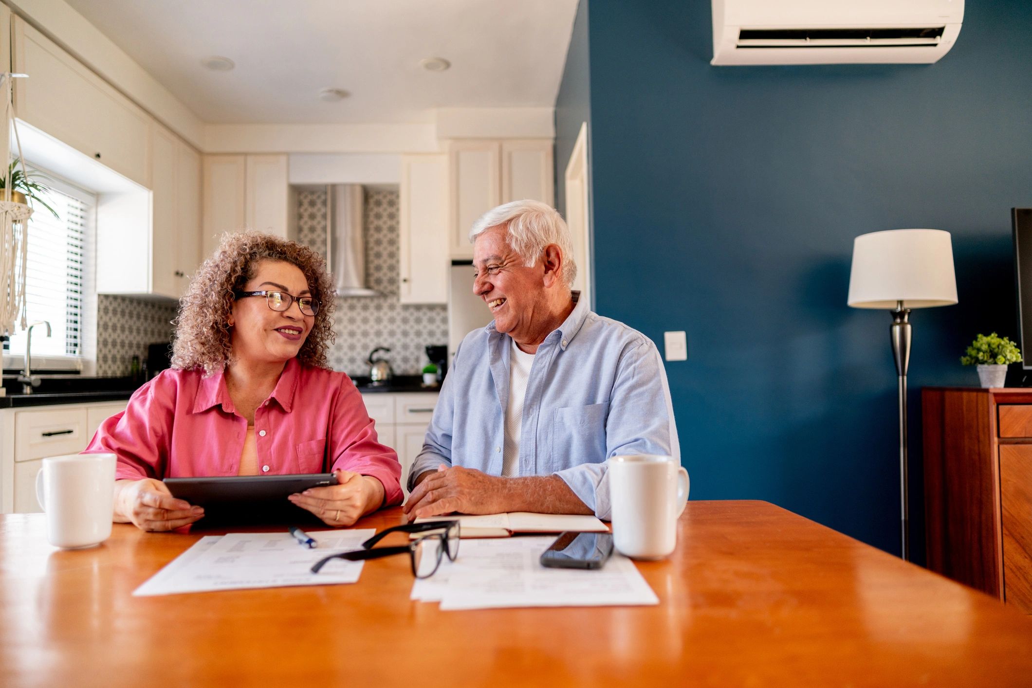 Couple reviewing paperwork at a kitchen table